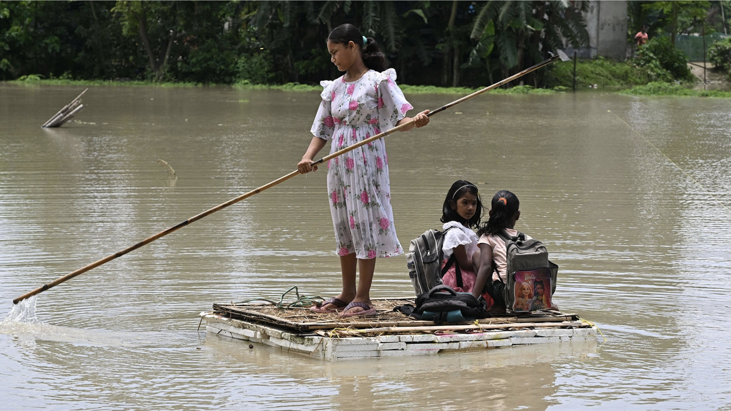 Children paddle through flood waters